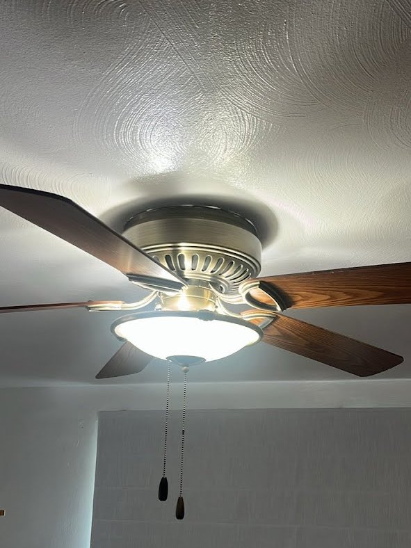 Before: an old ceiling fan with wood blades and a glass bowl light