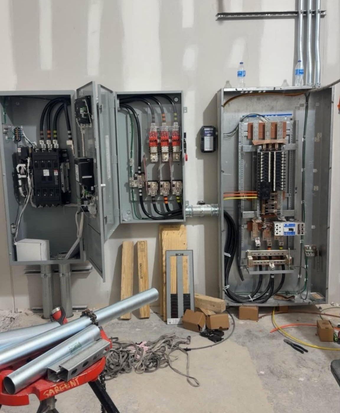 Large open switchgear and distribution panels being installed in a utility room
